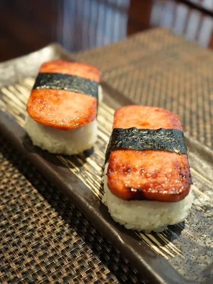Another angle of our unique Supamu Nigiri. The seared top and seasoned rice offer a comforting and savory flavor profile that was a highlight of our Okinawa Specials menu.