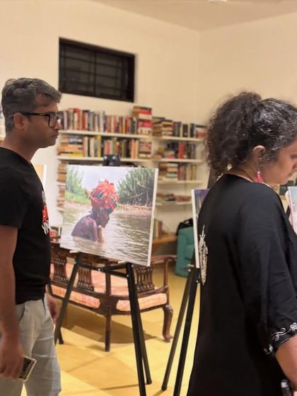 An intimate moment of observation at the "Chronicles of the Tides" photo exhibition.