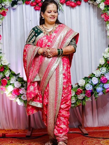 A customer looking lovely in a pink brocade Nauvari paired with a dark green blouse for a family wedding.