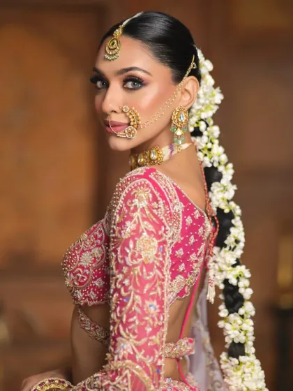 This image shows the intricate connection between the gajra braid and the model's shoulder, emphasizing the length and flow of the hairstyle as part of the complete look.