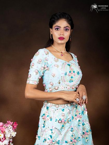 A close-up of the colorful eye makeup. The bright pink lip and bold eyeshadow create a look that is youthful, fun, and perfect for a daytime wedding event or festive party.