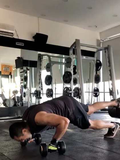 This is an advanced push-up variation using dumbbells to increase the range of motion and challenge stability. We're always finding new ways to push the limits and keep the body guessing.