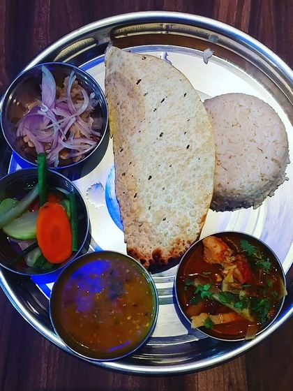 Another look at our Naga special thali, served in a traditional steel plate. You get a bit of everything, from dal and curry to pickles and salad, for a balanced and flavourful meal.