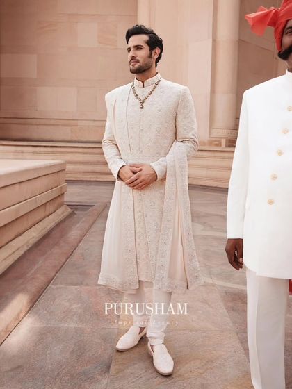 This layered sherwani, with its delicate drape and intricate embroidery, is designed for a grand entrance. It is a piece that feels both timeless and perfectly suited for a modern celebration.