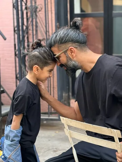 A heartwarming "like father, like son" moment. I had the pleasure of giving them matching man bun styles with sharp undercuts.