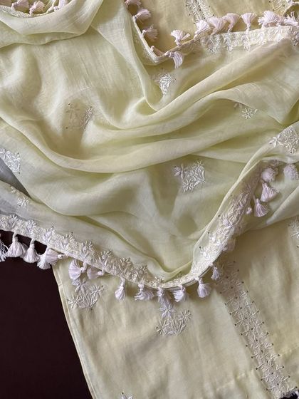 A detail shot of the mul dupatta, showcasing its soft texture, scattered Chikankari motifs, and tassel-adorned border.