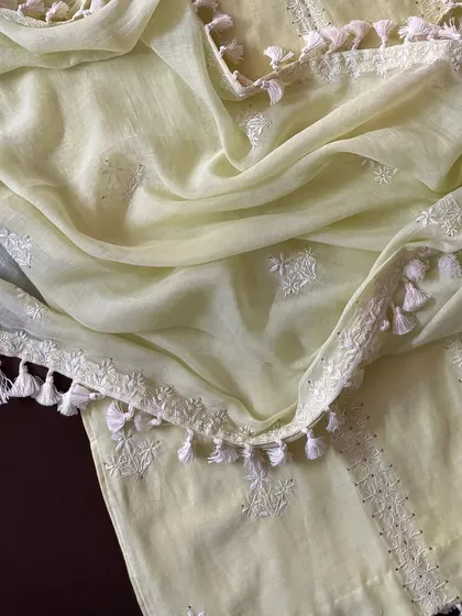 A detail shot of the mul dupatta, showcasing its soft texture, scattered Chikankari motifs, and tassel-adorned border.