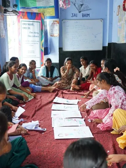This is a quiet moment from my 'Humaar Kahaani, Humaar Rang' workshop in Bihar. Here, a group of girls are deeply focused on their drawings, sharing stories and creating together on the floor. This image captures the safe, judgment-free space I strive to create, where everyone feels comfortable enough to express themselves.
