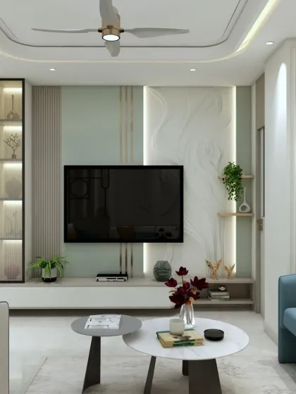 The TV unit in this 3BHK features a beautiful combination of a marble-finish panel and light green textured paint, creating a fresh and modern look.