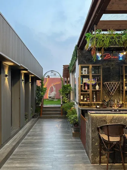 We design cohesive outdoor experiences. This view shows the seamless flow from the stylish bar area to the tranquil garden retreat, creating a multi-functional and luxurious terrace.