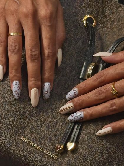 A chic and sophisticated take on animal print. This design pairs a subtle leopard pattern with clean nude nails and simple gold stripes. It's a great way to wear a bold pattern in a more understated and elegant way.