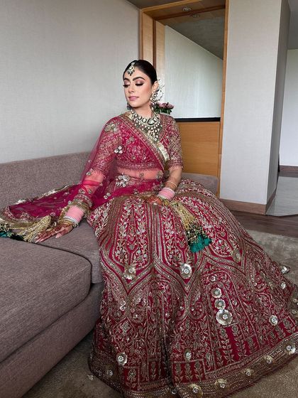 Another view of the bride on her wedding day, her classic bun a perfect choice for her elaborate outfit and jewelry.