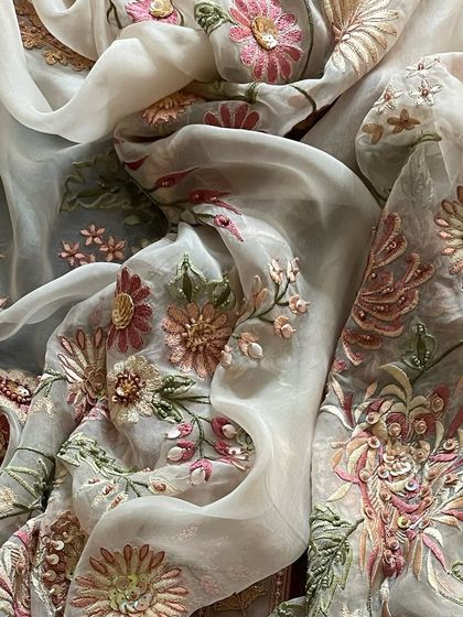 Another view of the draped dupatta, emphasizing its sheer and luxurious quality.