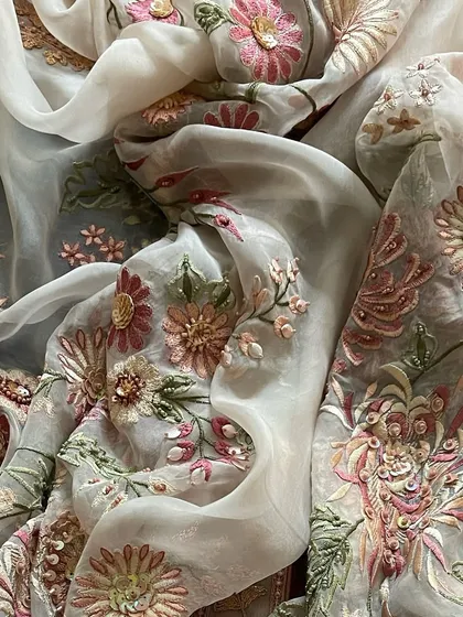 Another view of the draped dupatta, emphasizing its sheer and luxurious quality.