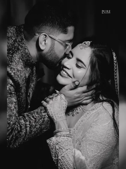 A beautiful black and white shot capturing a moment of pure happiness and affection between the newly engaged couple.