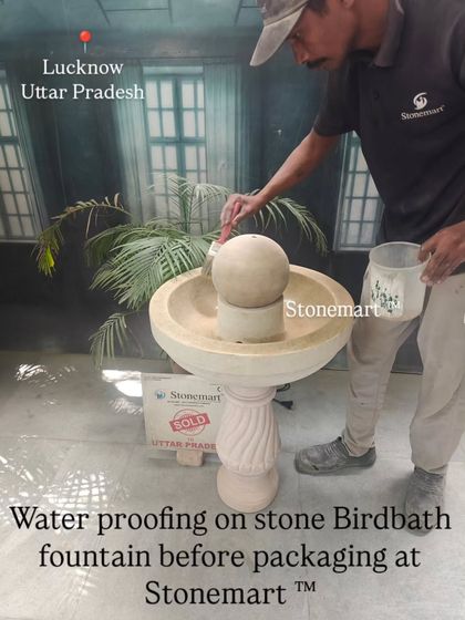 A close-up of the waterproofing process on a stone birdbath fountain. This ensures the longevity of the piece and makes it safe for both indoor and outdoor use.