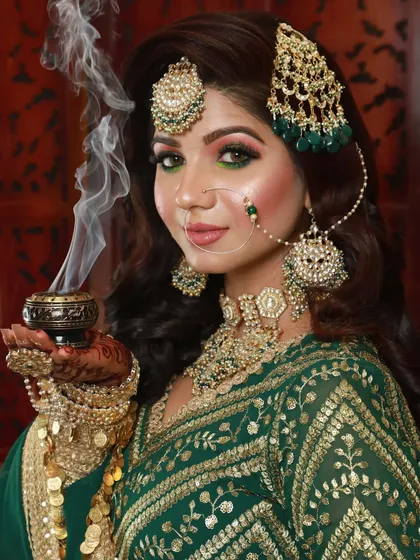 This bride chose a beautiful green outfit. I created a matching green smokey eye and a bold look to complement her unique style.