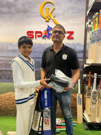 As a cricket parent, finding the right equipment is essential. Here we are at a local sports shop, selecting bats that have the right balance and ping for a young player.