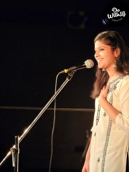 A performer's joyful expression as she shares her art. This is what our open mic nights are all about.