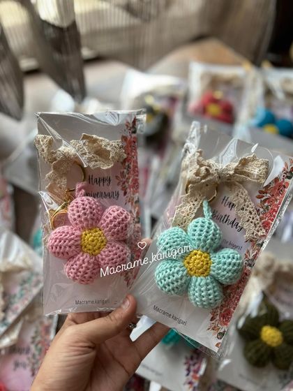 Two of our puff flower keychains packaged with "Happy Birthday" and "Happy Anniversary" cards. They make for a thoughtful and beautiful handmade gift for any occasion.