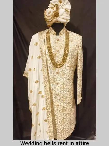 A full look at our classic ivory and gold sherwani, a timeless rental choice for any groom.