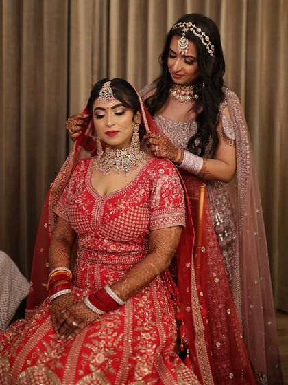 A candid moment between sisters on the wedding day. I had the honor of doing the makeup for both the bride and her sister, ensuring their looks were coordinated yet unique.