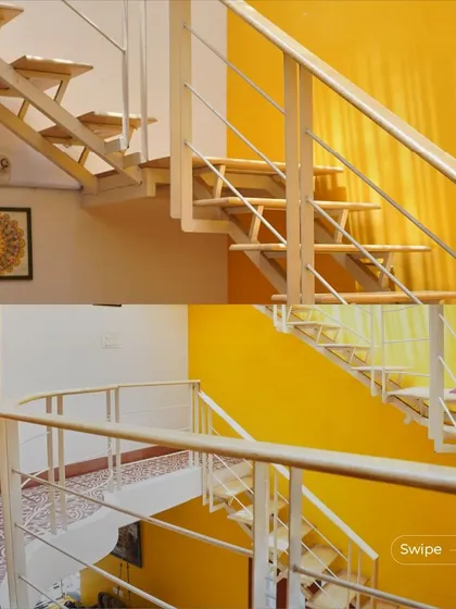 The floating metal staircase is a key feature of the design. Its light structure and open risers allow light and views to pass through, contributing to the home's airy feel.