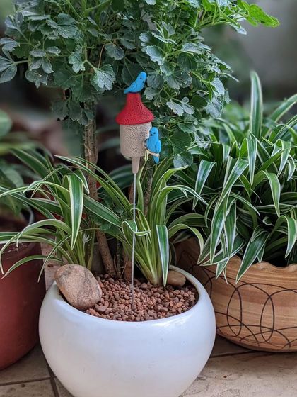 A birdhouse garden stake adds a touch of whimsy to any indoor planter. I love seeing how these little accessories bring a pot to life.