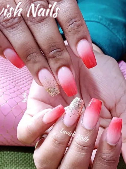 A vibrant red-to-nude ombre on coffin nails, with a touch of gold glitter on the accent nail.
