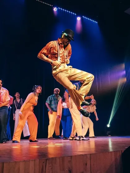 A dancer hits a dynamic jump, capturing the explosive and joyful energy of our Locking and Soul performance.