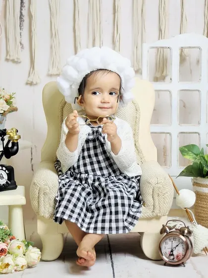 A quirky and fun "little old lady" theme for a sitter session. The pom-pom wig, glasses, and vintage props create a hilarious and memorable photo.