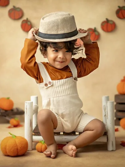 My cute little pumpkin! This autumn-themed shoot with a pumpkin patch setup is perfect for celebrating the season.