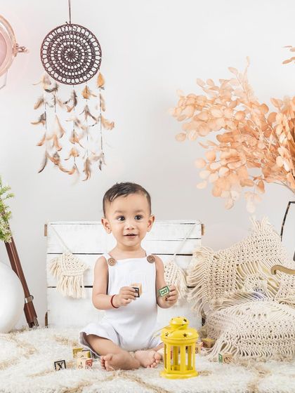 A full view of our boho lifestyle setup, with neutral colors, natural textures, and a happy baby boy.