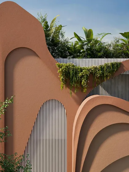 A close-up of the top of the facade, where lush greenery creates a rooftop garden, blurring the line between architecture and nature.