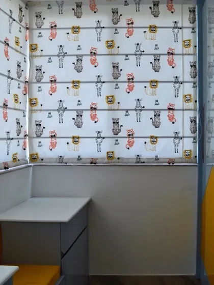 A detail of the custom Roman blinds with a playful animal pattern, adding a touch of fun and personality to the kids' room window.