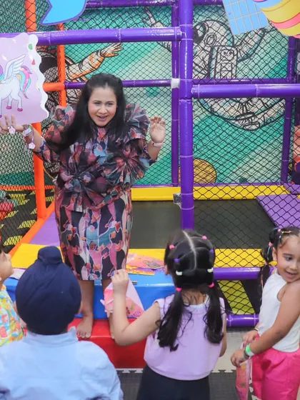 A guest entertainer engages the children with a fun and interactive game on the trampoline. I ensure there's always something exciting happening.