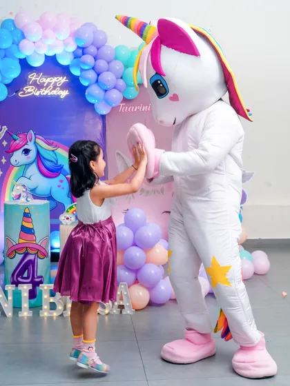 A high-five for a unicorn! We love capturing these magical and playful interactions between children and party entertainers.