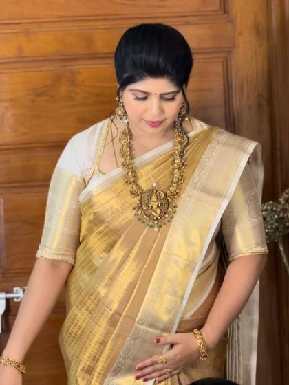 A close-up of Shilpa, showing her stunning temple jewelry that pairs perfectly with the golden silk saree.