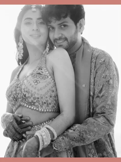 A classic black and white portrait of Rupanshi and Yash. The simple frame and their close embrace make for a timeless and romantic image.