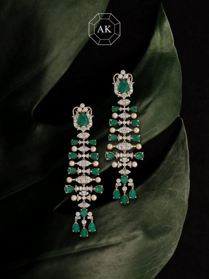 Where elegance meets emotion. These exquisite earrings are made with natural Zambian emeralds, Akoya pearls, and diamonds, handcrafted in 18K gold.