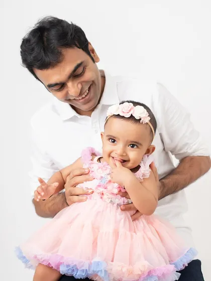 A father's playful interaction with his daughter brings out her adorable, curious expressions. These are the authentic moments I strive for.