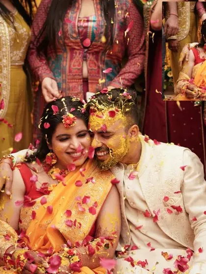 The Haldi ceremony is all about unrestrained joy. We love capturing these candid moments of celebration, like this one where the couple is showered with flower petals, creating a memory filled with laughter and color.