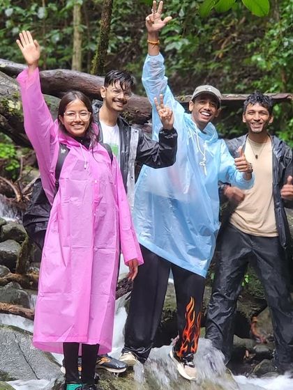 Waving hello from a stream crossing on the Kudremukha trail. Our treks are filled with fun moments like these, even in the rain.