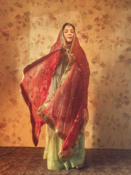 A beautiful, flowing shot of Neena Gupta in her red and mint green 'Dastoor' outfit.