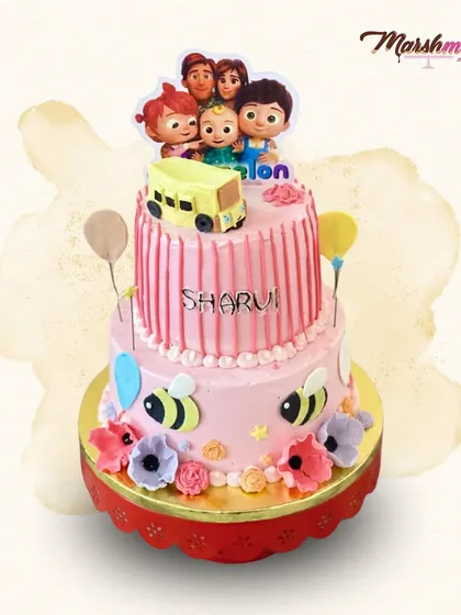 A vibrant two-tiered Cocomelon cake in shades of pink. This design features the whole family, along with cute bees and flowers, perfect for a little one's party.