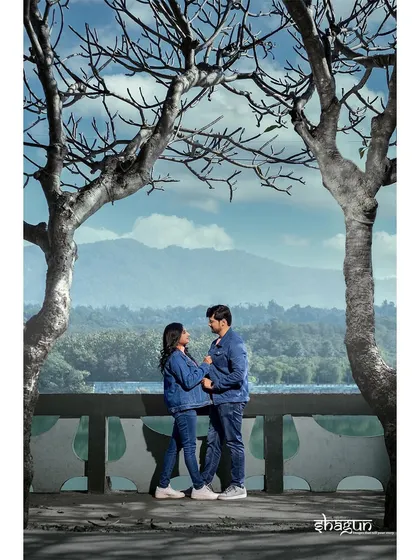 Framed by two trees against a stunning mountain and lake view. This shot combines a candid pose with an epic landscape, showing the best of both worlds.
