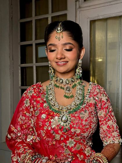 Radiant in red, this bride embodied tradition and timeless grace. The makeup was designed to complement her intricate jewelry and the rich color of her outfit.
