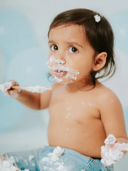 A close up of this little guy looking right at the camera, daring someone to take his cake. His expressions were priceless throughout the session.