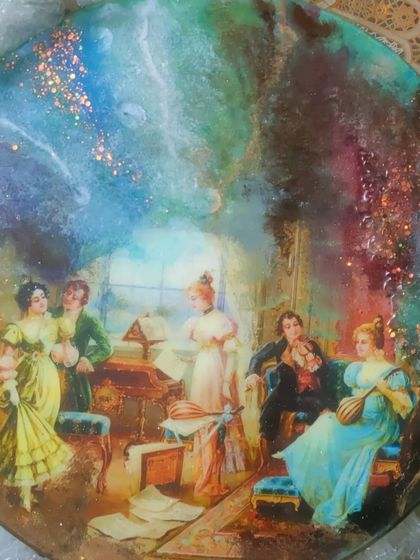 Here is the finished mix-media resin art piece. The combination of the vintage image with the abstract, sparkling resin background creates a stunning piece of wall decor that blends classical and modern styles.