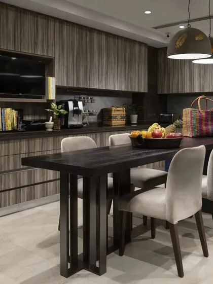 The large, eat-in kitchen in the Caitriona apartment, designed for a food connoisseur. It features hardwood countertops, ample storage with specialized ventilation, and durable laminate finishes for a blend of style and high functionality.
